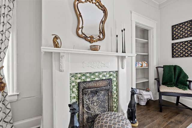 sitting room with crown molding and wood-type flooring