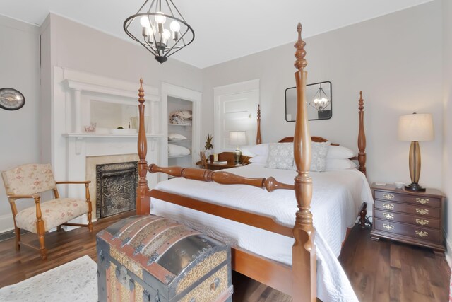 424 S 4th St, Danville, KY 40422 - bedroom featuring a chandelier, wood finished floors, and a fireplace