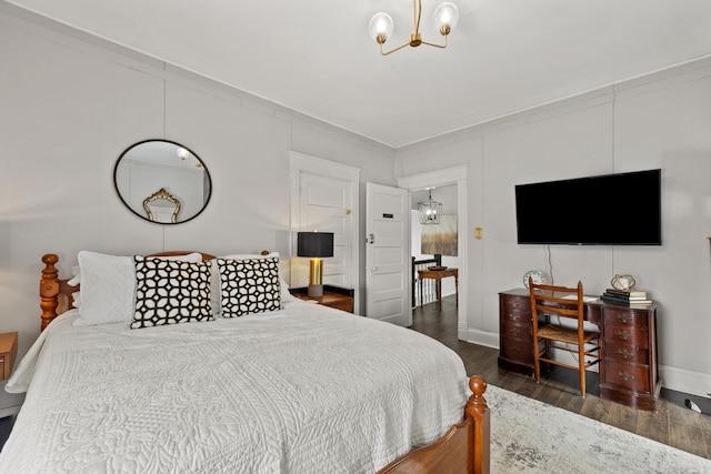 bedroom featuring a chandelier and dark hardwood / wood-style floors