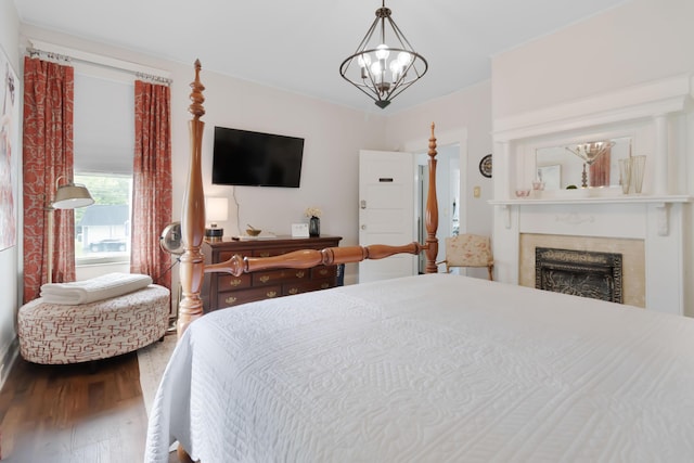 424 S 4th St, Danville, KY 40422 - bedroom featuring wood finished floors, a fireplace, and a chandelier