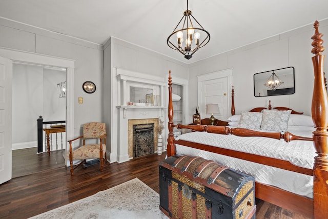 bedroom featuring a chandelier, crown molding, and dark wood-type flooring