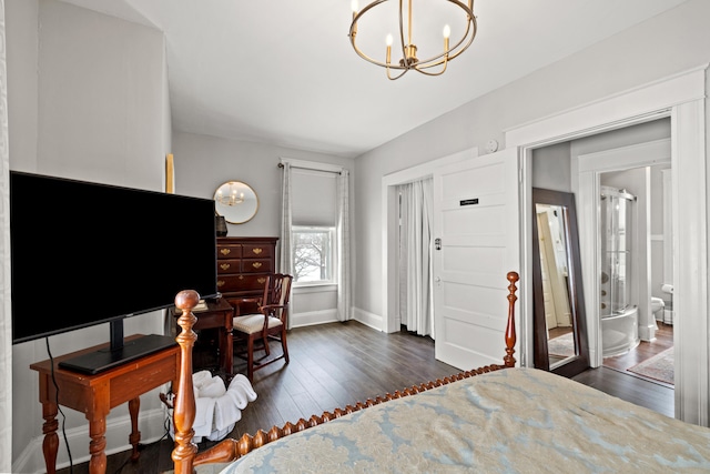 bedroom with ensuite bath, dark wood-type flooring, and a notable chandelier