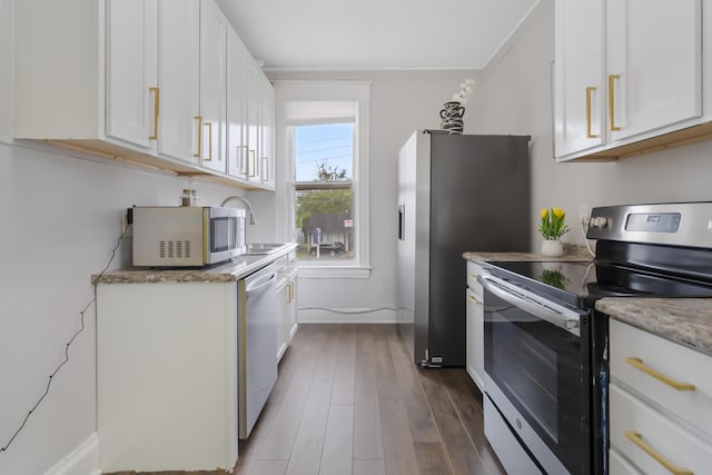 424 S 4th St, Danville, KY 40422 - kitchen with appliances with stainless steel finishes, dark wood-style flooring, white cabinets, and baseboards