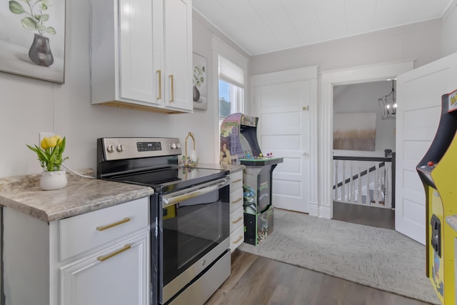 424 S 4th St, Danville, KY 40422 - kitchen featuring stainless steel range with electric stovetop, wood finished floors, white cabinetry, light countertops, and ornamental molding