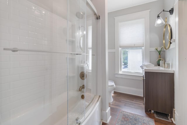 424 S 4th St, Danville, KY 40422 - bathroom with toilet, wood finished floors, vanity, shower / bath combination with glass door, and baseboards
