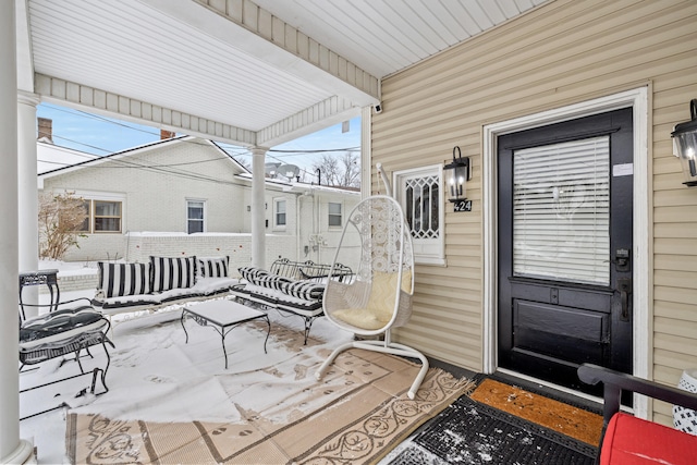 snow covered patio with a porch