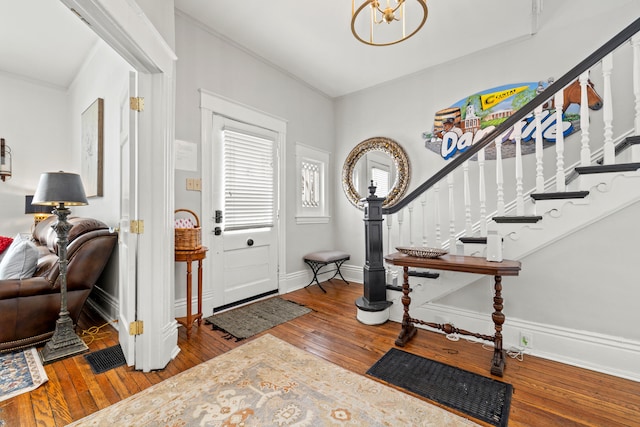 foyer entrance with hardwood / wood-style flooring and an inviting chandelier