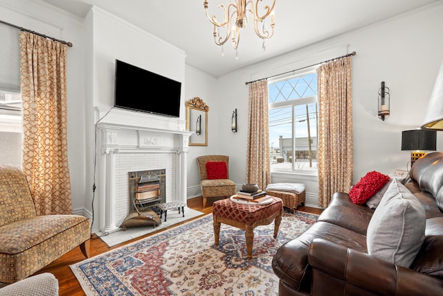 living room with hardwood / wood-style flooring, a notable chandelier, and crown molding