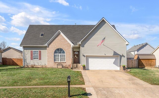 view of front of property featuring a front yard and a garage