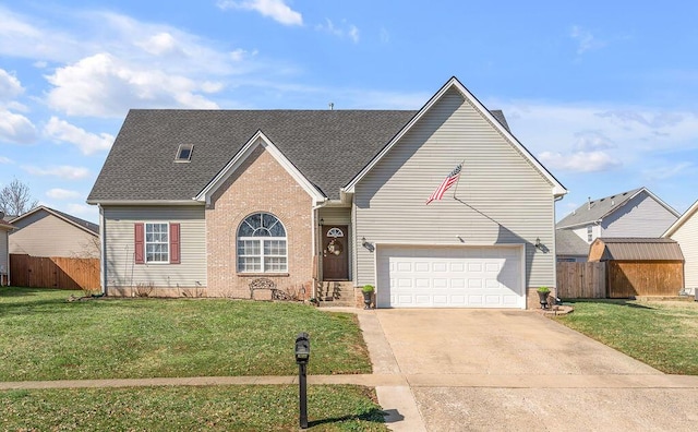 view of front of home featuring driveway, a front yard, fence, and brick siding