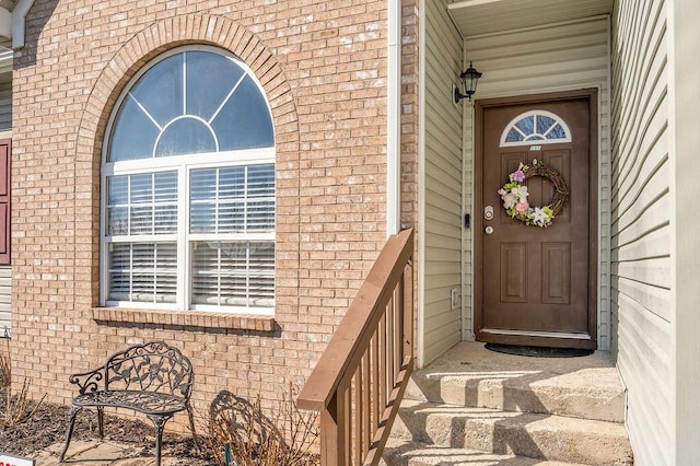 doorway to property with brick siding