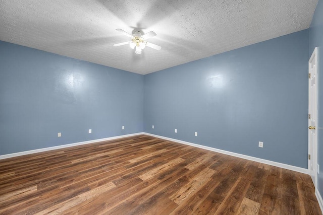 empty room featuring dark wood-style floors, a textured ceiling, baseboards, and a ceiling fan