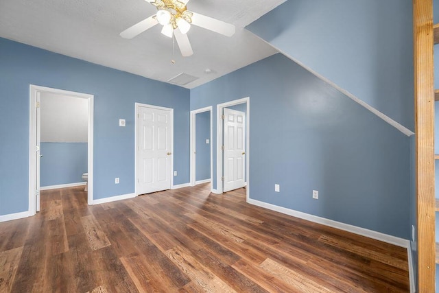 unfurnished bedroom featuring dark wood-style flooring, a ceiling fan, and baseboards