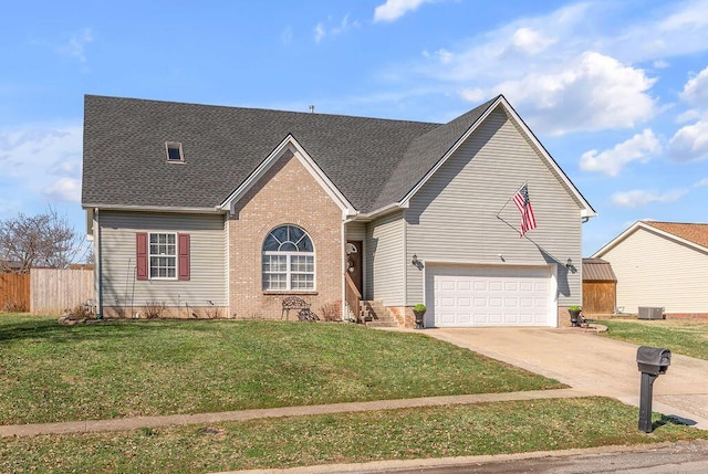 view of front of house featuring driveway, brick siding, a front yard, and fence