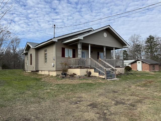 view of front of house with covered porch and a front yard