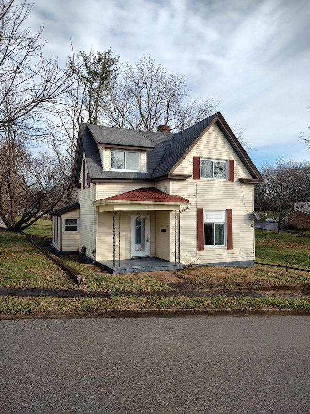 view of front of home with covered porch and a front lawn