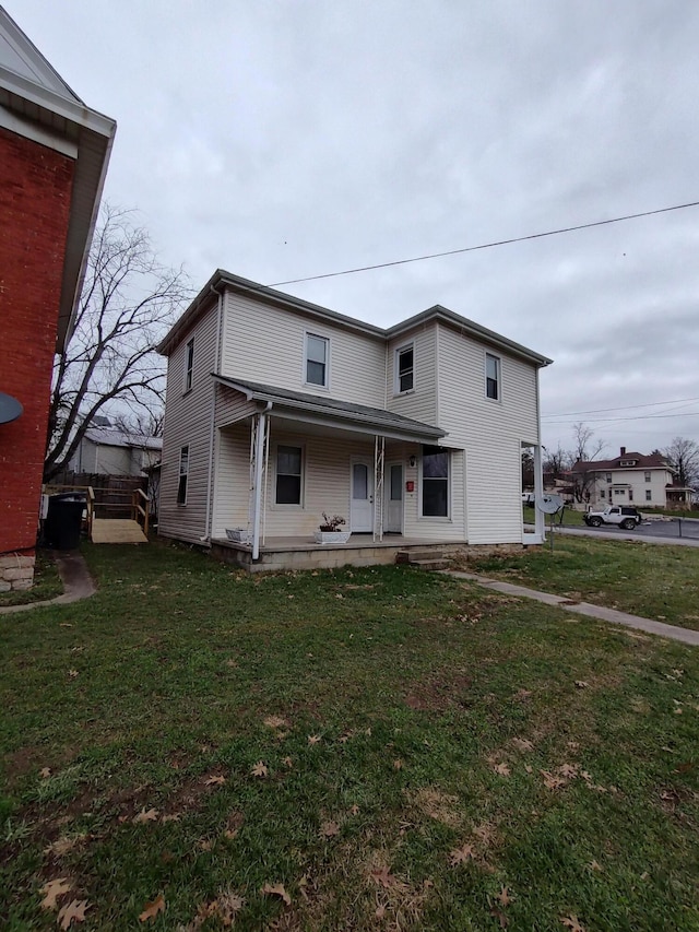 view of front facade featuring a front lawn and covered porch