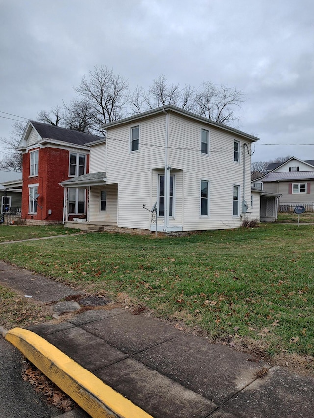 back of property with a lawn