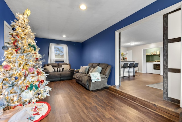 living room with dark hardwood / wood-style floors and washing machine and clothes dryer