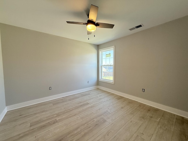 empty room with light hardwood / wood-style flooring and ceiling fan