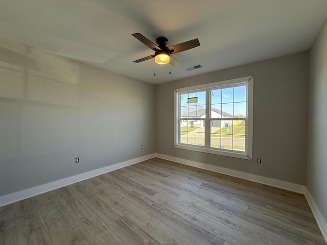 spare room featuring ceiling fan and light wood-type flooring