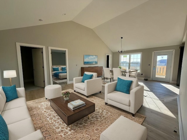 living room featuring high vaulted ceiling and light hardwood / wood-style floors