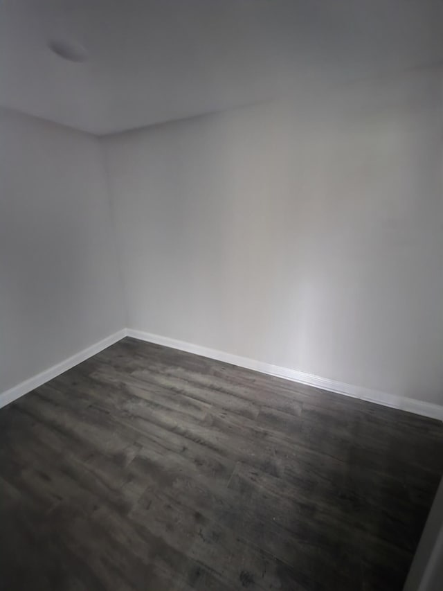 spare room with dark hardwood / wood-style floors