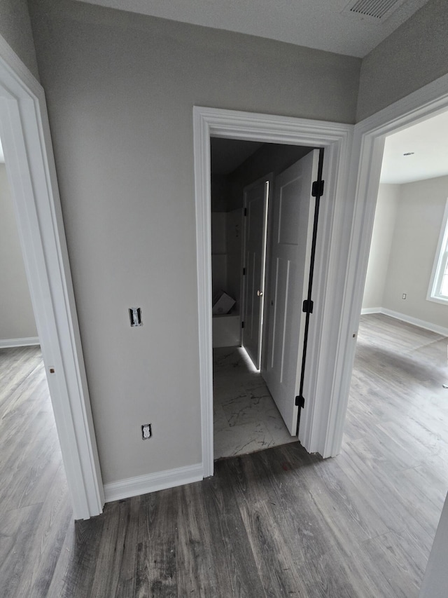 corridor featuring wood-type flooring