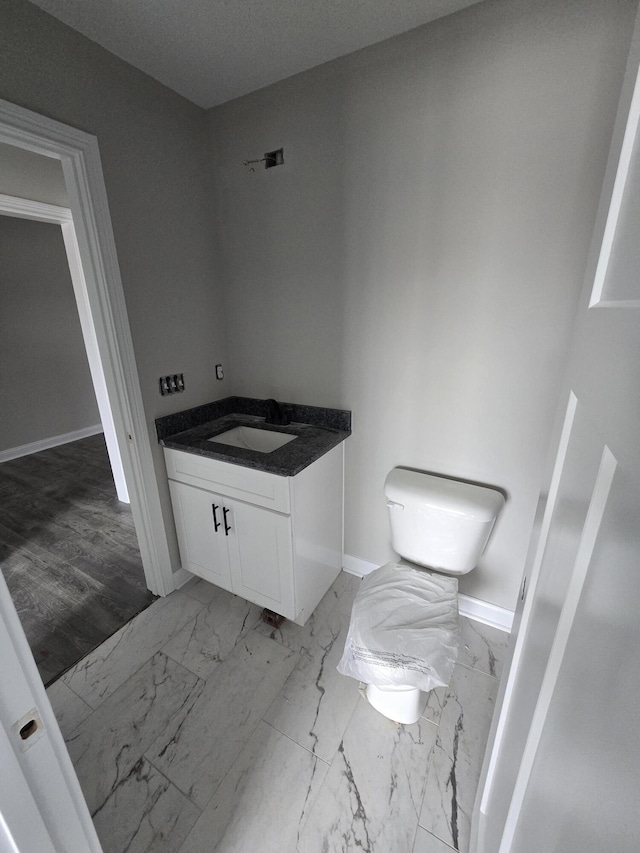 bathroom featuring toilet and vanity