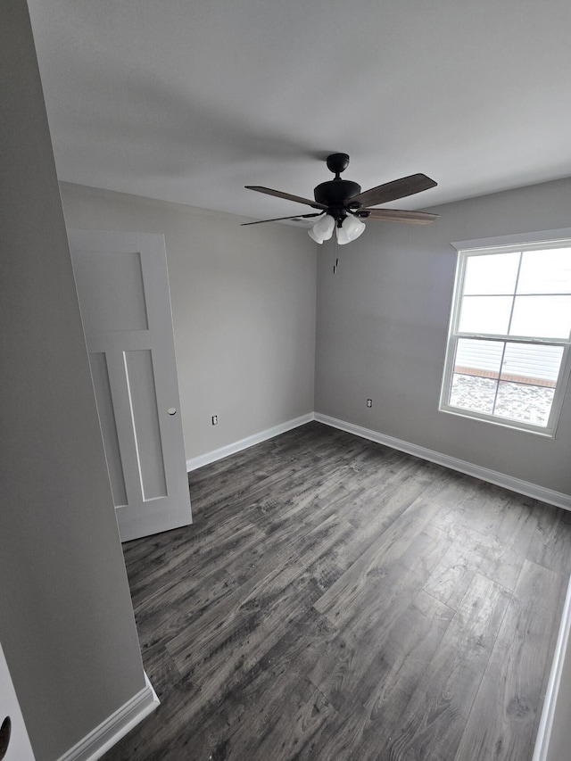 spare room with dark hardwood / wood-style floors and ceiling fan