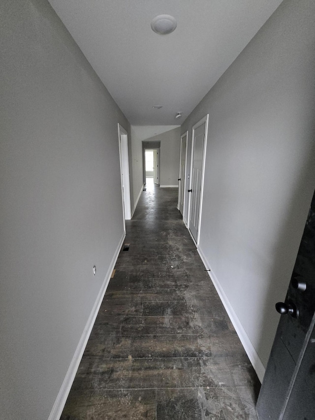 corridor featuring dark wood-type flooring