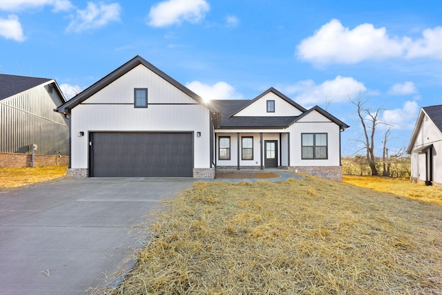 modern farmhouse with a front yard and a garage