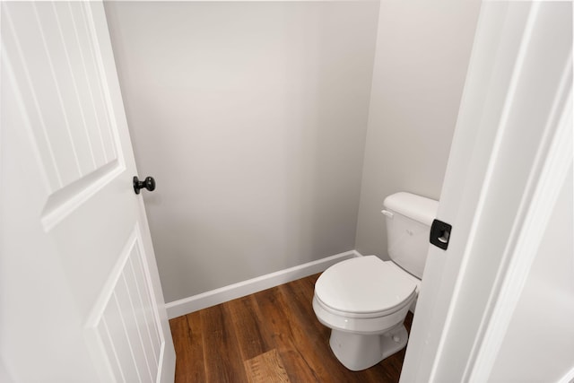 bathroom with hardwood / wood-style floors and toilet