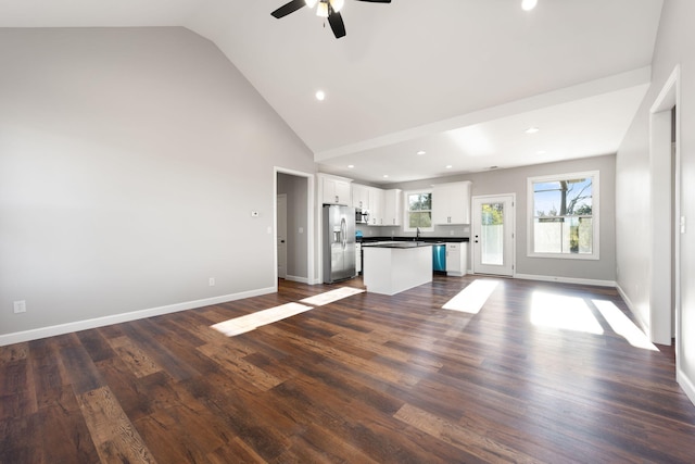 kitchen featuring white cabinets, dark hardwood / wood-style floors, ceiling fan, appliances with stainless steel finishes, and a kitchen island