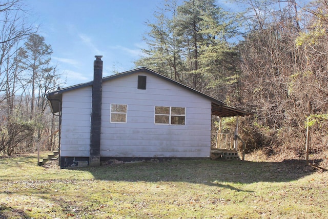 view of side of home with a lawn