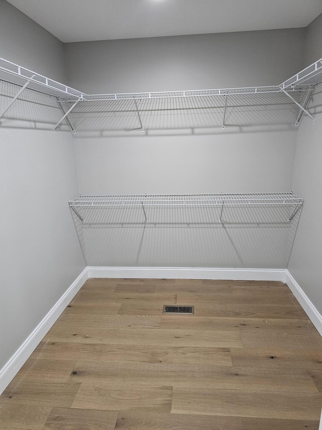 spacious closet with visible vents and wood finished floors