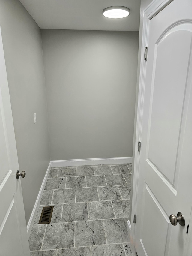 laundry area with visible vents and baseboards