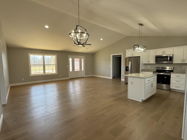 kitchen featuring dark wood-style floors, stainless steel appliances, open floor plan, white cabinets, and a kitchen island