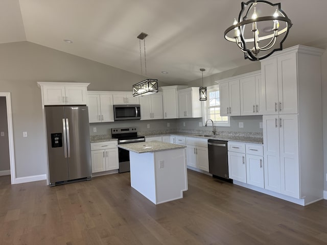 kitchen with stainless steel appliances, a sink, white cabinets, a center island, and dark wood finished floors