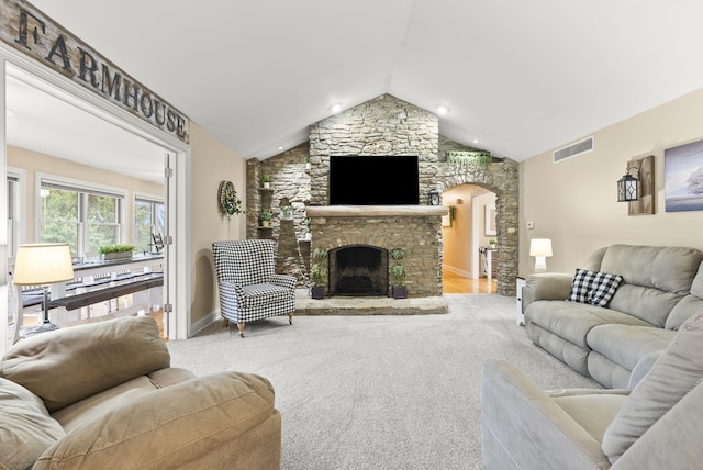 carpeted living room featuring a fireplace and lofted ceiling