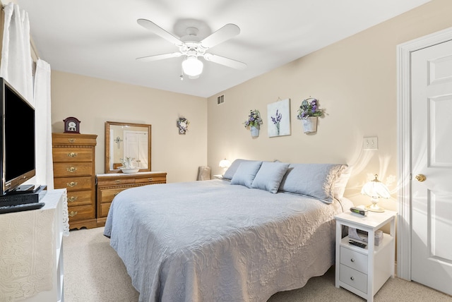 bedroom featuring ceiling fan and light carpet