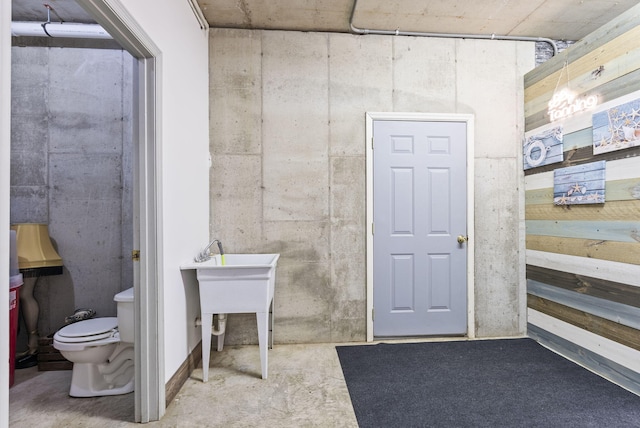 bathroom featuring toilet and concrete floors