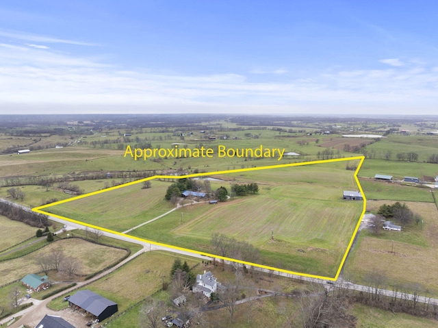 birds eye view of property with a rural view