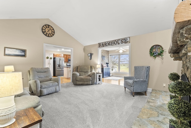 living room featuring carpet flooring, ceiling fan, and lofted ceiling