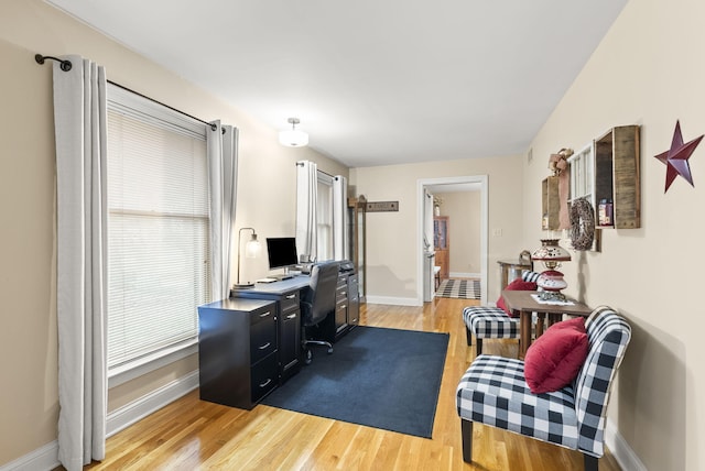 office area with a wealth of natural light and light hardwood / wood-style floors