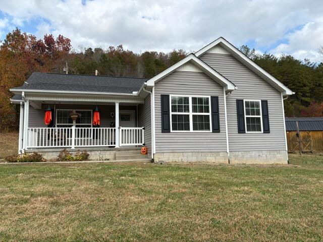 view of front of house with covered porch and a front yard