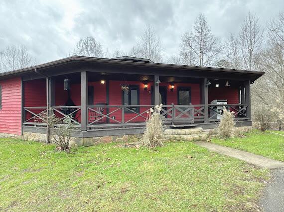 rear view of house featuring a lawn