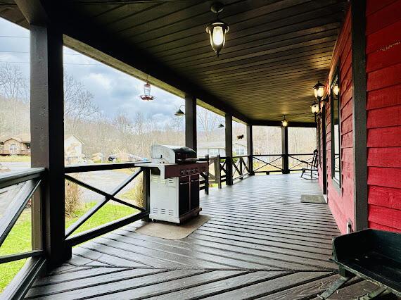 deck featuring covered porch and area for grilling