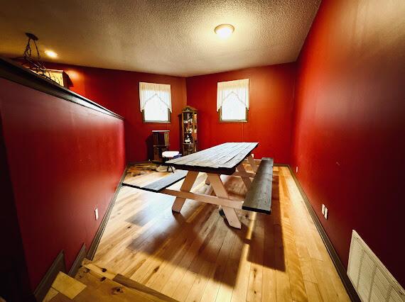 interior space with light hardwood / wood-style floors and a textured ceiling