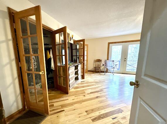 interior space with french doors and light hardwood / wood-style floors